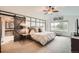 Spacious main bedroom features a sliding barn door to the en suite, modern furnishings, and a large window with an outdoor view at 527 Stonemont Dr, Castle Pines, CO 80108