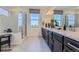 Bathroom with dual vanity, modern tiled shower, and plenty of natural light from the windows at 13960 Hanging Lake St, Parker, CO 80138