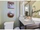 Stylish bathroom with a modern mirror and vanity, accented by decorative wall art at 13960 Hanging Lake St, Parker, CO 80138