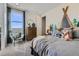 Bright bedroom with a camping themed design, a large window, and comfortable furnishings at 13960 Hanging Lake St, Parker, CO 80138