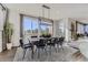 Bright dining room with modern light fixture and large window that brings in natural light at 13960 Hanging Lake St, Parker, CO 80138