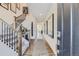 Inviting hallway featuring wood floors, a staircase with a wrought iron railing, and natural light at 13960 Hanging Lake St, Parker, CO 80138