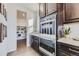 A modern kitchen features stainless steel appliances, dark wood cabinets, and access to a spacious pantry at 13960 Hanging Lake St, Parker, CO 80138