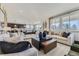 Open-concept living room with neutral decor, connecting seamlessly to the kitchen and dining areas at 13960 Hanging Lake St, Parker, CO 80138