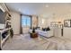 Inviting living room with a plush white sofa, chandelier, and a large window at 13960 Hanging Lake St, Parker, CO 80138
