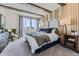 Comfortable bedroom with exposed wood beams, a king size bed, and large windows at 13960 Hanging Lake St, Parker, CO 80138