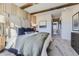 Cozy bedroom showcasing a king size bed, exposed beams, and large windows at 13960 Hanging Lake St, Parker, CO 80138
