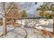 Snowy backyard with trees and a tall wooden privacy fence at 2590 S Meade St, Denver, CO 80219