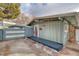 Ranch home with attached garage and a gray exterior, red door, and dark deck at 2590 S Meade St, Denver, CO 80219