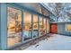 View of living room through large windows overlooking winter backyard at 2590 S Meade St, Denver, CO 80219