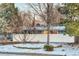 Front yard of house with snow and privacy fence at 2590 S Meade St, Denver, CO 80219