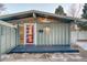 Mid-century modern home with a red door and dark gray deck at 2590 S Meade St, Denver, CO 80219