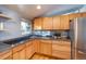 Updated kitchen with stainless steel appliances and light wood cabinets at 2590 S Meade St, Denver, CO 80219