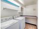 Bright laundry room with washer, dryer, and ample counter space at 2590 S Meade St, Denver, CO 80219