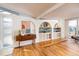 Living room with built-in shelving and hardwood floors at 2590 S Meade St, Denver, CO 80219