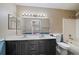 Bathroom with a double sink vanity, large mirror and a bathtub at 3845 Canyon Ranch Rd # 102, Highlands Ranch, CO 80126