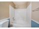 Bathtub and shower combo with white tiling and updated showerhead at 3845 Canyon Ranch Rd # 102, Highlands Ranch, CO 80126