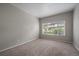 Cozy bedroom with neutral walls, a window and carpeted flooring at 3845 Canyon Ranch Rd # 102, Highlands Ranch, CO 80126