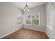 Bright dining area featuring wood-look tile floors, natural light and a modern light fixture at 3845 Canyon Ranch Rd # 102, Highlands Ranch, CO 80126