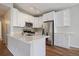 A renovated kitchen featuring stainless steel appliances, white cabinets, and stone countertops, ready for cooking at 3845 Canyon Ranch Rd # 102, Highlands Ranch, CO 80126