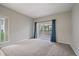 A lovely living room featuring a neutral color scheme, soft carpeting, and sliding glass doors to a private balcony at 3845 Canyon Ranch Rd # 102, Highlands Ranch, CO 80126