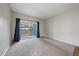 A great view of the living room with plush carpet and a deck, perfect for relaxing and enjoying the outdoors at 3845 Canyon Ranch Rd # 102, Highlands Ranch, CO 80126