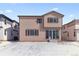 Tan home featuring sliding glass door and snowy backyard at 9165 Truckee Ct, Commerce City, CO 80022