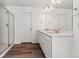 Bright bathroom featuring double sinks, a quartz countertop, and walk-in shower with tile surround at 9165 Truckee Ct, Commerce City, CO 80022