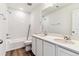 Bright bathroom featuring double sinks, a quartz countertop, and shower/tub combo with tile surround at 9165 Truckee Ct, Commerce City, CO 80022