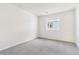 A bedroom featuring neutral carpet, fresh paint, and a window with views of neighborhood at 9165 Truckee Ct, Commerce City, CO 80022