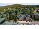 Aerial view of a townhome community nestled amongst lush greenery with ample parking and mountain views at 31112 Black Eagle Dr # 101, Evergreen, CO 80439