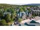 Aerial view of townhomes nestled among mature trees, offering serene community living and convenient parking at 31112 Black Eagle Dr # 101, Evergreen, CO 80439