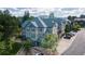 Aerial view of a charming townhome with lush landscaping, ample parking and mountain views at 31112 Black Eagle Dr # 101, Evergreen, CO 80439