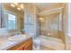 Bathroom with granite counters, tub with shower and tile surround at 31112 Black Eagle Dr # 101, Evergreen, CO 80439