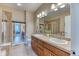 Bathroom features double sink, tile floor and shower with glass door at 31112 Black Eagle Dr # 101, Evergreen, CO 80439