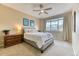 Serene bedroom with a large window, ceiling fan, neutral decor and a comfortable queen size bed at 31112 Black Eagle Dr # 101, Evergreen, CO 80439