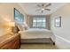 Comfortable bedroom featuring a plush bed, ceiling fan, and a scenic view from the large window at 31112 Black Eagle Dr # 101, Evergreen, CO 80439