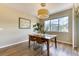 Bright dining room featuring a wood table, modern light fixture, hardwood flooring, and large windows at 31112 Black Eagle Dr # 101, Evergreen, CO 80439