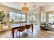 Well-lit dining room with hardwood floors, a pendant light fixture, large windows, and access to the patio at 31112 Black Eagle Dr # 101, Evergreen, CO 80439
