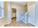 Inviting entryway featuring wood flooring, staircase, and access to basement at 31112 Black Eagle Dr # 101, Evergreen, CO 80439
