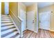 Welcoming foyer with wood flooring and staircase leading to upper levels at 31112 Black Eagle Dr # 101, Evergreen, CO 80439