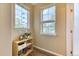 Cozy hallway nook with natural light streaming through the windows and a stylish bookshelf at 31112 Black Eagle Dr # 101, Evergreen, CO 80439
