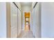 Hallway with carpet and slider-door closets leading to a bathroom with tile floors at 31112 Black Eagle Dr # 101, Evergreen, CO 80439