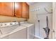 Practical laundry room featuring a washer, dryer, overhead cabinets and convenient shelving at 31112 Black Eagle Dr # 101, Evergreen, CO 80439