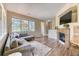 Spacious living room featuring large windows and cozy fireplace at 31112 Black Eagle Dr # 101, Evergreen, CO 80439