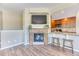 Living room featuring a fireplace and open view into the kitchen area at 31112 Black Eagle Dr # 101, Evergreen, CO 80439