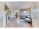 Sunlit living room with fireplace and open layout to kitchen and dining at 31112 Black Eagle Dr # 101, Evergreen, CO 80439