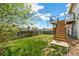A lush, green lawn stretches across the backyard with a privacy fence and multi-level deck at 19804 E Villanova Pl, Aurora, CO 80013