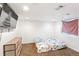 Basement bedroom with carpet, a dresser, and a television at 19804 E Villanova Pl, Aurora, CO 80013