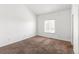 This bedroom offers natural light from the window, complemented by neutral carpet flooring and walls at 19804 E Villanova Pl, Aurora, CO 80013